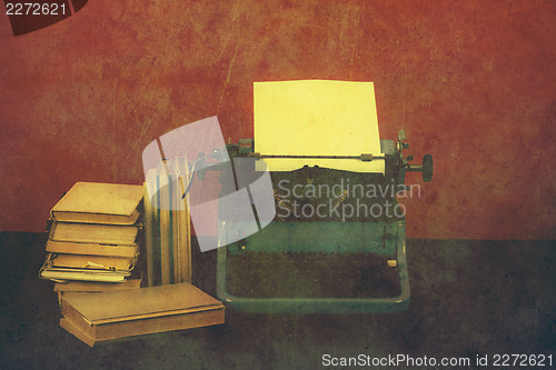 Image of Old typewriter with books retro colors on the desk