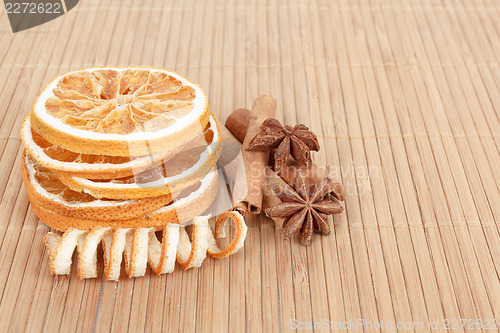 Image of Star Anise, cinnamon and dried orange wooden background 
