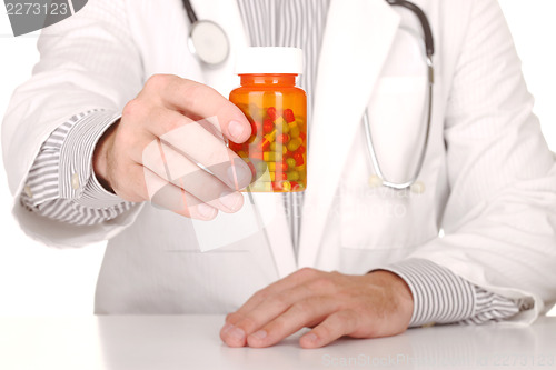 Image of Doctor With Medication in Prescription Bottles