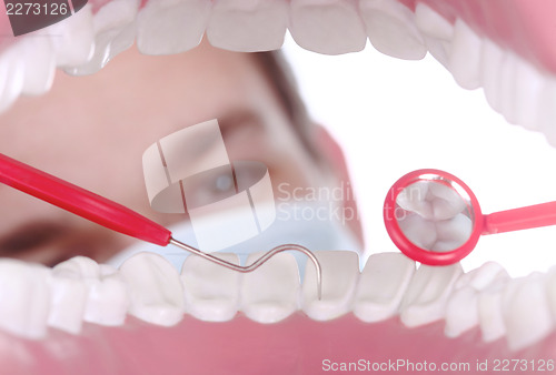 Image of Caucasian Dentist Working Inside a Patient Mouth