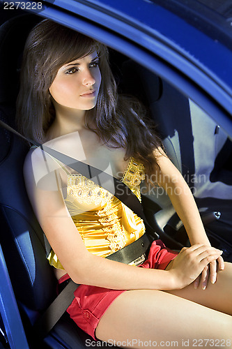 Image of girl in car fastened by seat belt