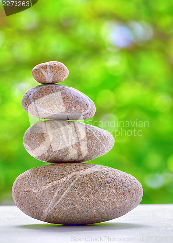 Image of stone pyramid over natural background