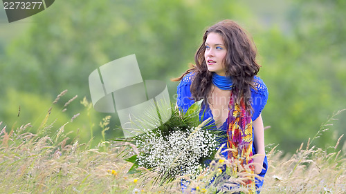 Image of girl with bouquet  in field