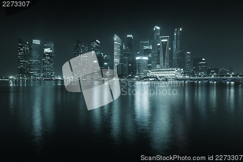 Image of Singapore skyline at night - skyscrapers with reflections.