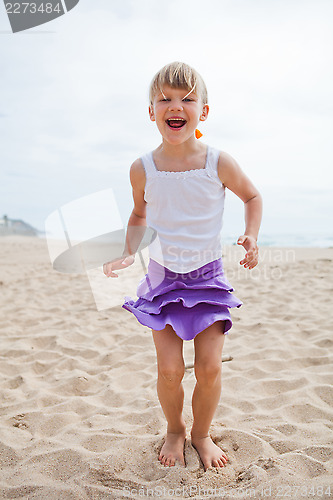 Image of Young girl playing on beach