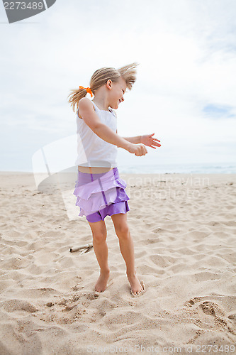 Image of Young girl playing on beach