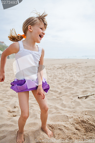 Image of Young girl playing on beach