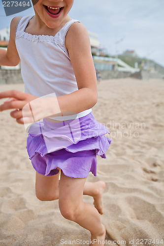 Image of Young girl playing on beach