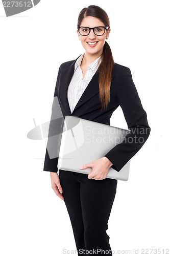 Image of Confident female manager holding laptop