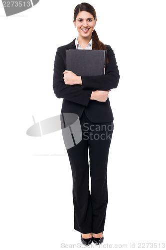 Image of Pretty female secretary holding business files