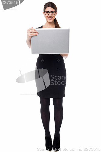 Image of Smart businesswoman holding a laptop
