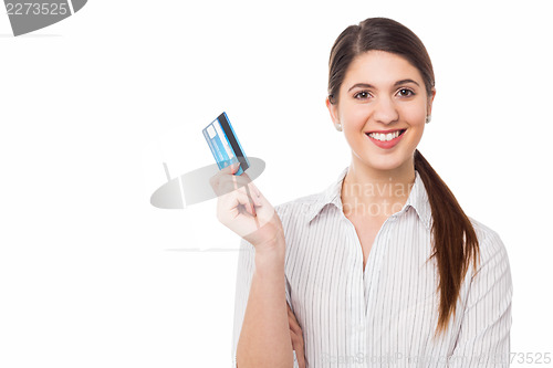 Image of Smiling elegant woman holding credit card