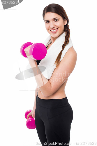 Image of Young girl lifting dumbbells, biceps exercise