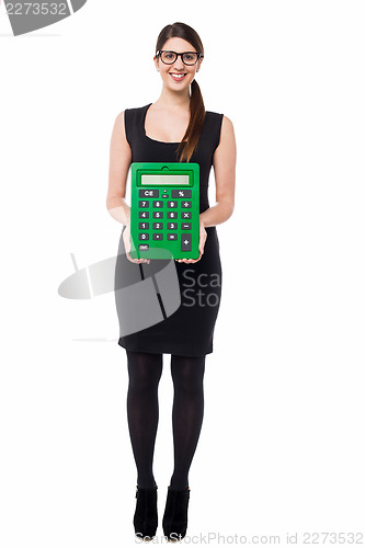 Image of Bespectacled young female displaying calculator