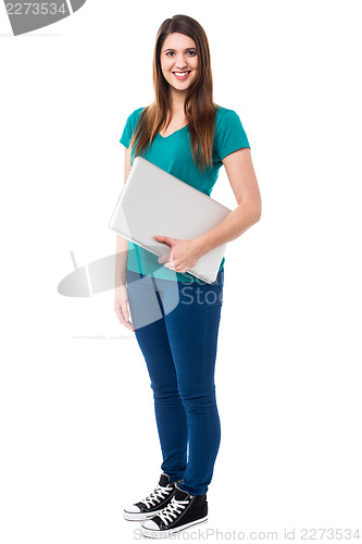 Image of Casual attractive girl holding laptop