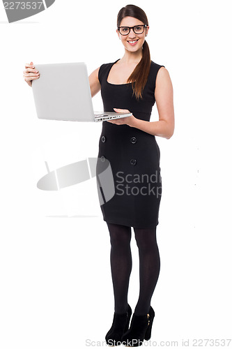 Image of Smart corporate lady holding a laptop
