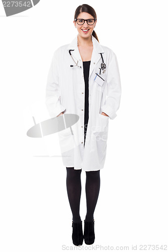 Image of Female physician posing with hands in lab coat