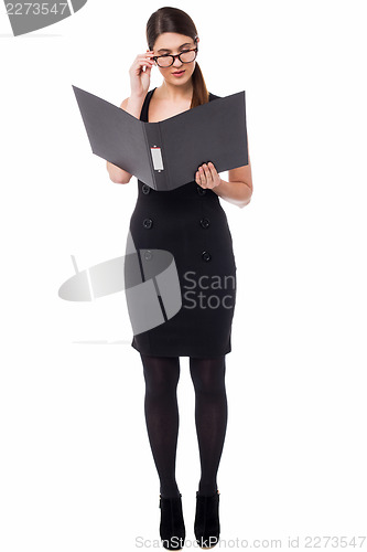Image of Corporate woman reviewing annual document