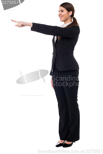 Image of Corporate smiling woman pointing at something