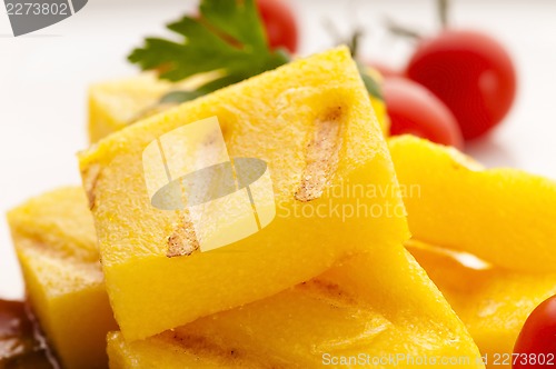 Image of Polenta taragna with sauce and tomatoes