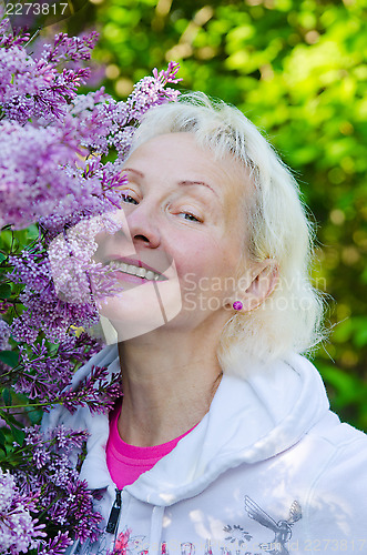 Image of Portrait of a woman from a Bush blooming lilac 
