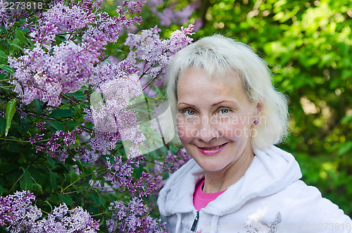 Image of Portrait of a woman from a Bush blooming lilac 