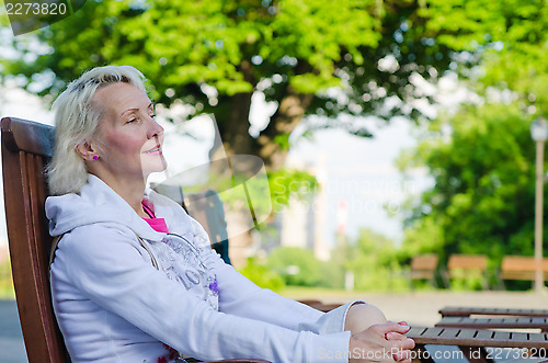 Image of Portrait of a woman relaxing at a table summer Cafe