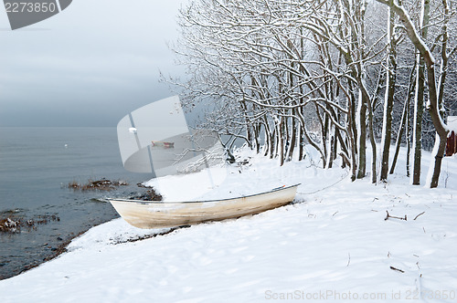 Image of Winter landscape with a fishing boat on seacoast