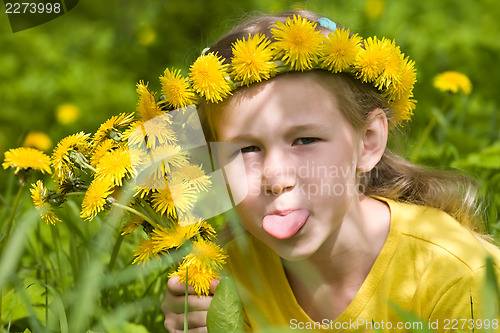 Image of little girl in dandelion wreath showing her tongue