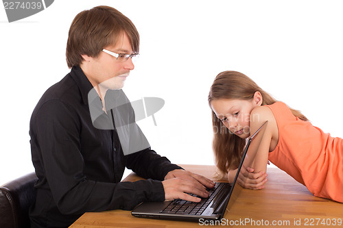 Image of Daughter looks at her father's laptop