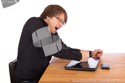 Image of Angry man knock with his fist on his laptop