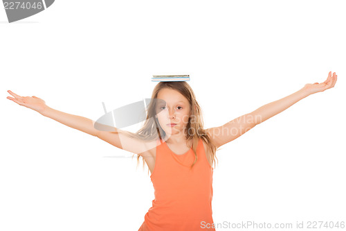 Image of Child with a book on her head