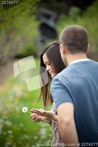 Image of Woman Holding a Dandelion