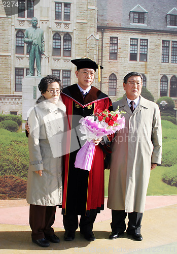 Image of South Korean university graduate with his parents - EDITORIAL ON
