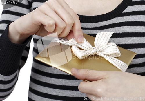 Image of Young woman holding a present