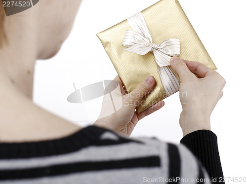 Image of Young woman holding a present