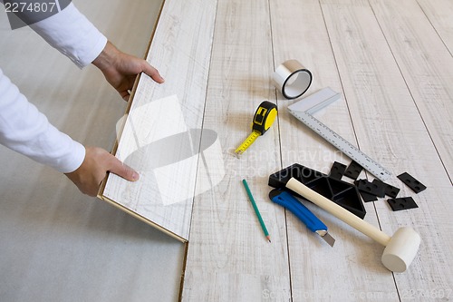 Image of Worker laying laminated