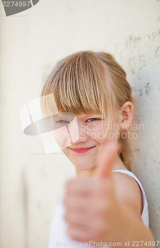 Image of Young girl doing ok sign