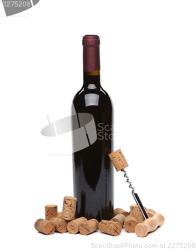 Image of A bottle of wine, corks and corkscrew.