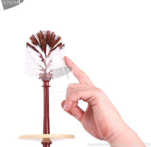 Image of A toilet brush and a hand