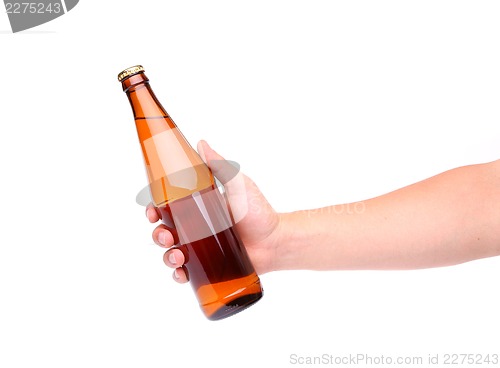 Image of A hand holding up a yellow beer bottle