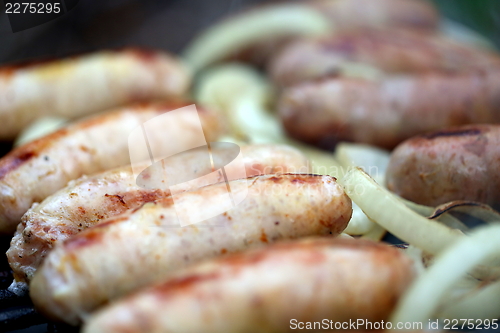 Image of BBQ a lot of sausages with onion
