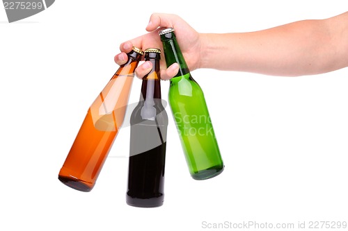 Image of Man's hand holding three beer bottle