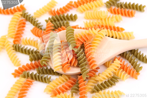 Image of A pasta eliche tricolori and a wood spoon.