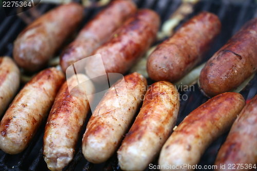 Image of A lot of grilled sausages close up, barbecue