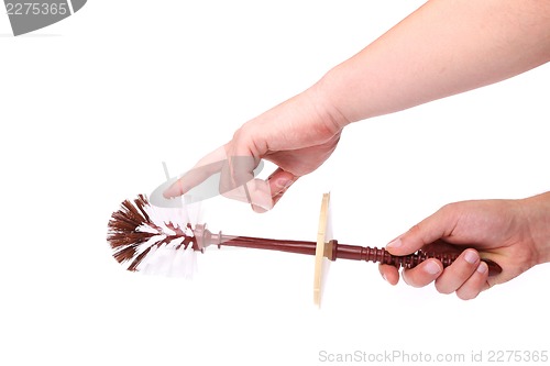 Image of Brown toilet brush isolated in hand.