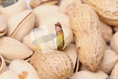 Image of One open pistachio and peanuts
