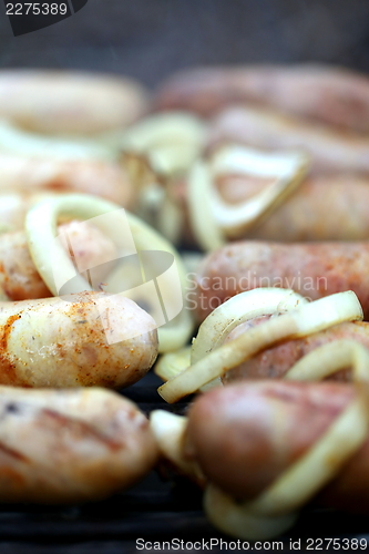 Image of BBQ a lot of tips sausages with onion