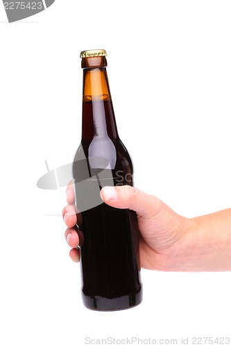 Image of A hand holding up a brown beer bottle