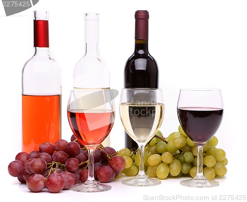 Image of Ripe grapes, wine glasses and bottles of wine